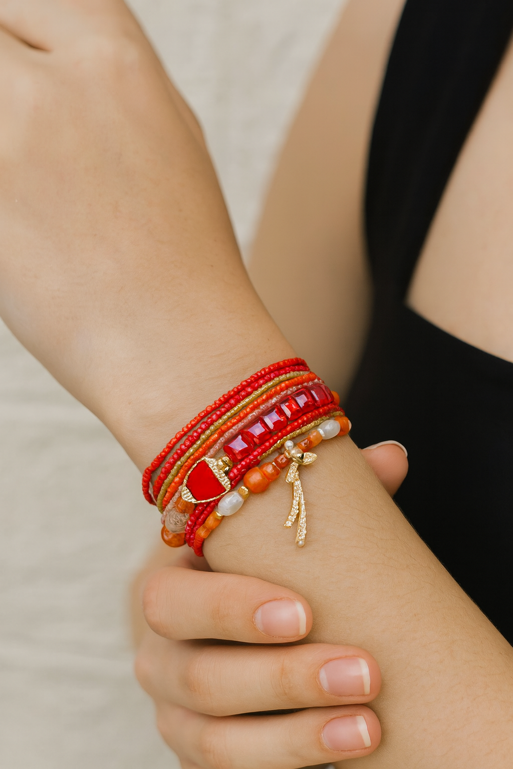 Red bracelet stack with a heart charm